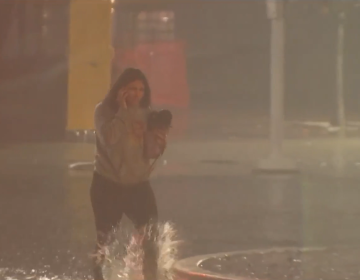 women caught on flooded streets